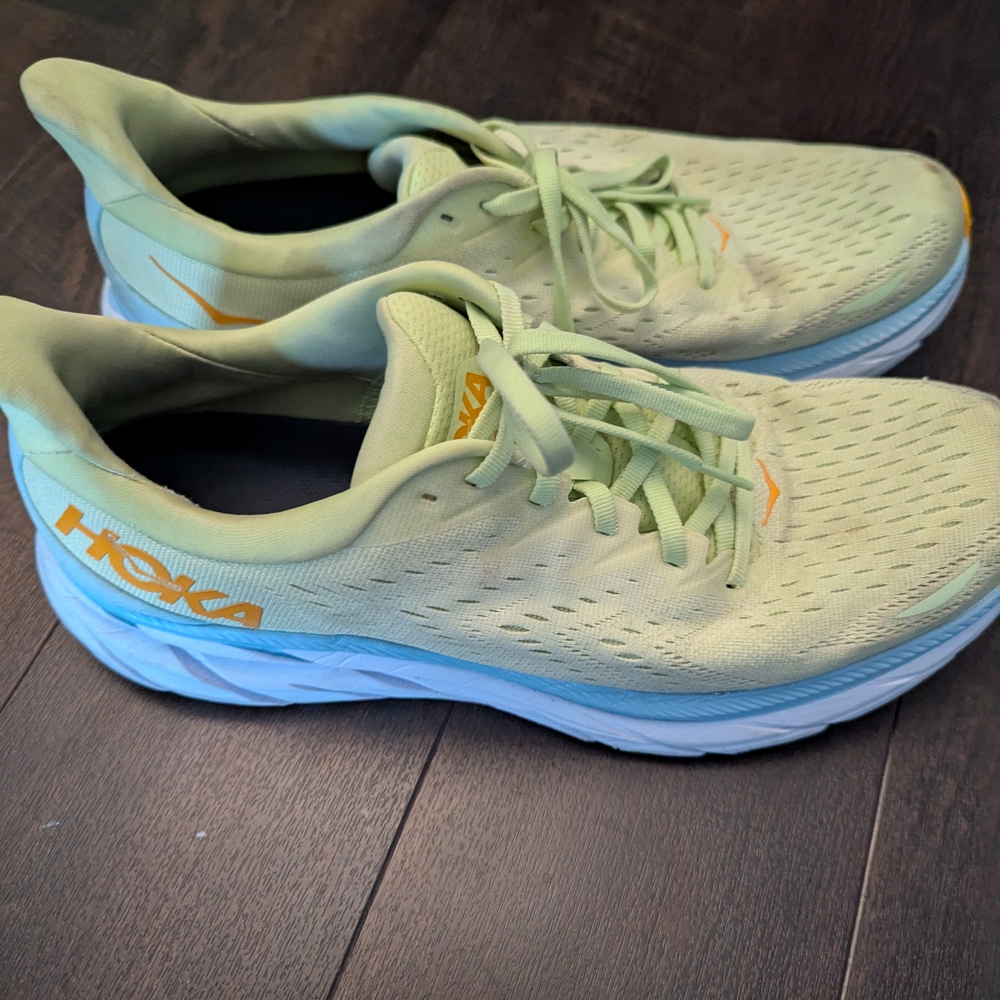 Hoka Athletic Shoes with Orange and Gray Soles